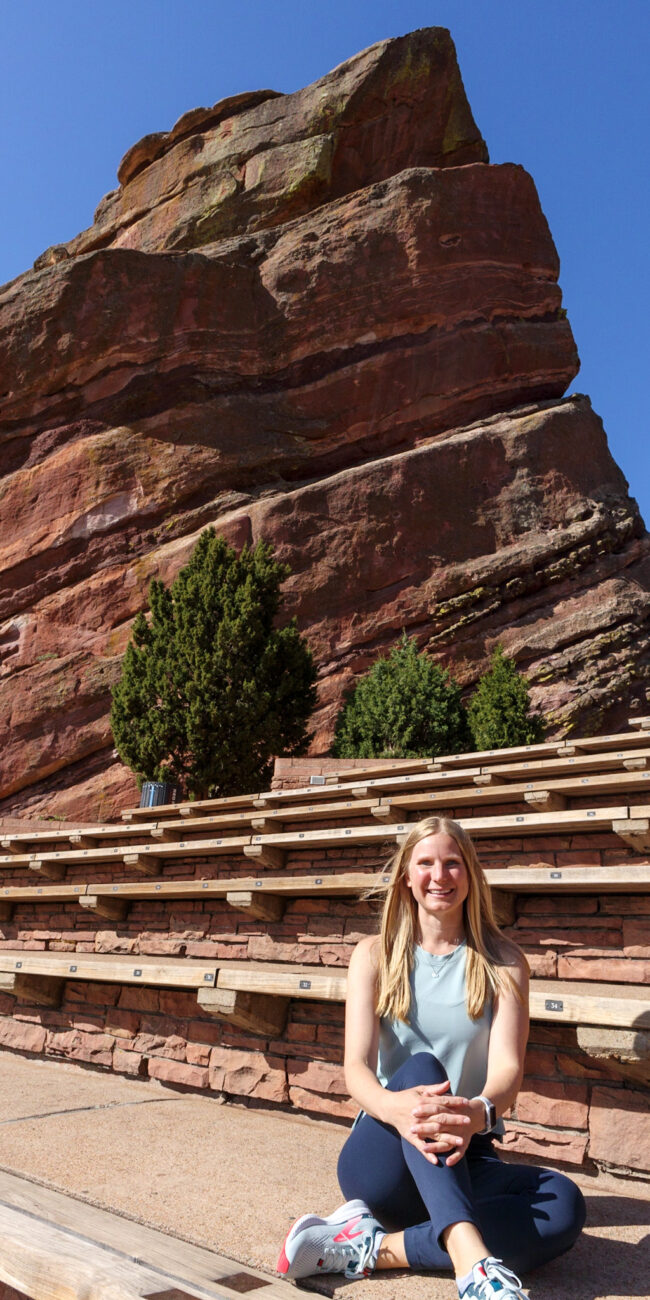 Functional and Integrative Medicine Provider Alison Percowycz, MSN, FNP-C sitting within Red Rocks Amphitheater in Colorado